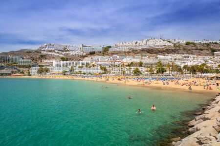 PUERTO RICO, SPAIN - APRIL 21, 2016: Beach of Puerto Rico with many tourists, Gran Canaria. Puerto Rico is a specially constructed holiday resort situated on the south-west coast of Gran Canaria.のeditorial素材