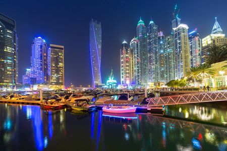 DUBAI, UAE - 31 MARCH 2014: Skyscrapers of Dubai Marina at night, UAE. Dubai Marina is a district in Dubai with artificial canal city who accommodates more than 120,000 people at Persian Gulf.のeditorial素材