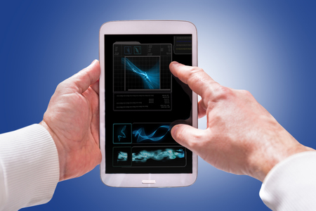 Touchscreen tablet computer in hands with technology screenの写真素材