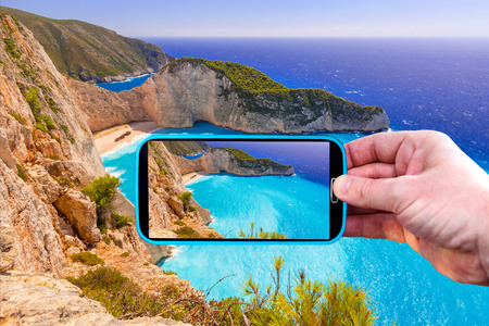 Making photos by smartphone of Navagio beach in Greeceの写真素材