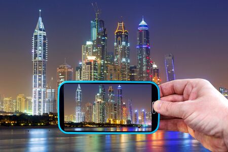 Making photos by smartphone in Dubai at night, UAEの写真素材