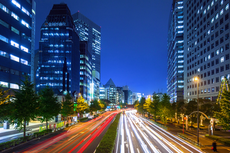 TOKYO, JAPAN - NOVEMBER 14, 2016: Cityscape of Shinjuku district with traffic lights on the street of Tokyo, Japan. Tokyo Metropolis is both the capital and most populous city of Japan.のeditorial素材