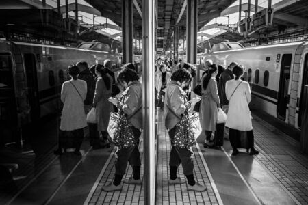 KYOTO, JAPAN - NOVEMBER 12, 2016: People waiting for train on the train station in Kyoto, Japan. West Japan Railway (JR West) is one of the biggest railway companies in Japan.のeditorial素材