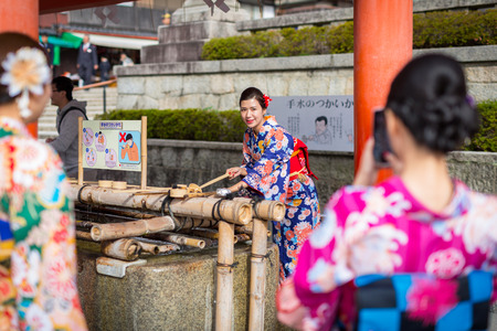 KYOTO, JAPAN - NOVEMBER 10, 2016: Young women wearing traditional japanese kimonos at Fushimi Inari Shrine in Kyoto, Japan. Kimono is a Japanese traditional garment.のeditorial素材