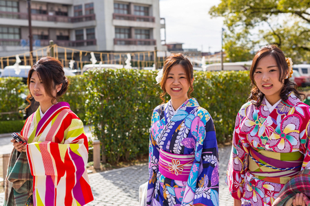 KYOTO, JAPAN - NOVEMBER 10, 2016: Young women wearing traditional japanese kimonos at Fushimi Inari Shrine in Kyoto, Japan. Kimono is a Japanese traditional garment.のeditorial素材