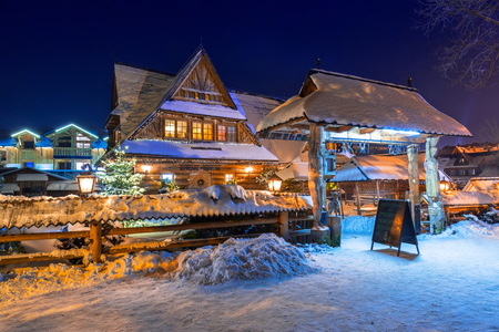ZAKOPANE, POLAND - DECEMBER 30, 2016: Wooden architecture of Zakopane at snowy night, Poland. City center of Zakopane is the main shopping area with pedestrian promenade in Tatra mountains.のeditorial素材