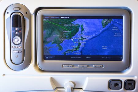 TOKYO, JAPAN - NOVEMBER 6, 2016: Multimedia system with navigation map of Boeing 777 during a flight from Frankfurt to Tokyo, Japan. Boeing 777 is a long range  jet airliners manufactured in USA.のeditorial素材