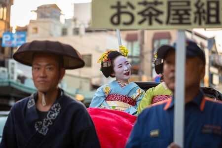 KYOTO, JAPAN - NOVEMBER 11, 2016: Maiko women, apprentice geisha on the street parade in Kyoto, Japan. Kyoto was formerly the Imperial capital of Japan for more than one thousand years.のeditorial素材