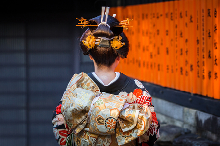 KYOTO, JAPAN - NOVEMBER 11, 2016: Woman wearing traditional japanese kimono walk on the street of Gion, Kyoto old town, Japan. Kimono is a Japanese traditional garment.のeditorial素材