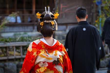 KYOTO, JAPAN - NOVEMBER 11, 2016: Woman wearing traditional japanese kimono walk on the street of Gion, Kyoto old town, Japan. Kimono is a Japanese traditional garment.のeditorial素材