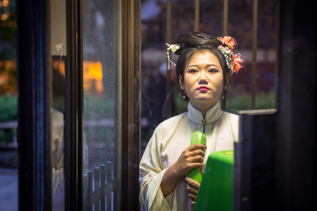 KYOTO, JAPAN - NOVEMBER 10, 2016: Young woman wearing traditional japanese kimono walk on the street of Gion, Kyoto old town, Japan. Kimono is a Japanese traditional garment.のeditorial素材