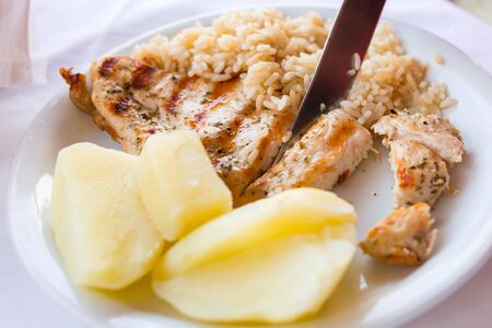 Grilled chicken fillt with potatoes and rice for kidsの写真素材