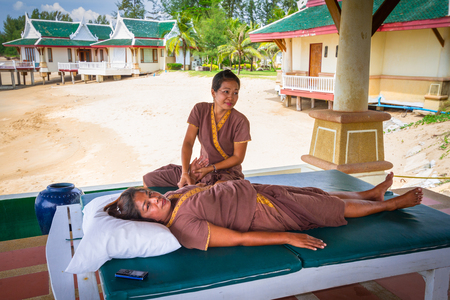 KOH KHO KHAO, THAILAND - NOVEMBER 10, 2012: Thai masseuses on the tropical beach of Koh Kho Khao island in Thailand. Thai massage is an ancient healing system.のeditorial素材
