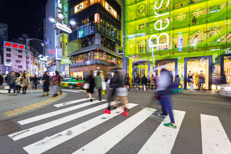 TOKYO, JAPAN - NOVEMBER 12, 2016: Busy streets of Shibuya district in Tokyo at night, Japan. Shibuya is the shopping district which surrounds Shibuya Station, one of Tokyo's busiest railway stations.のeditorial素材