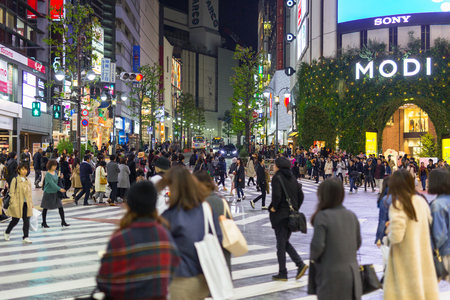 TOKYO, JAPAN - NOVEMBER 12, 2016: Busy streets of Shibuya district in Tokyo at night, Japan. Shibuya is the shopping district which surrounds Shibuya Station, one of Tokyo's busiest railway stations.のeditorial素材