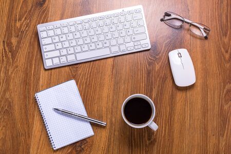 Modern office workplace with a cup of coffeeの写真素材