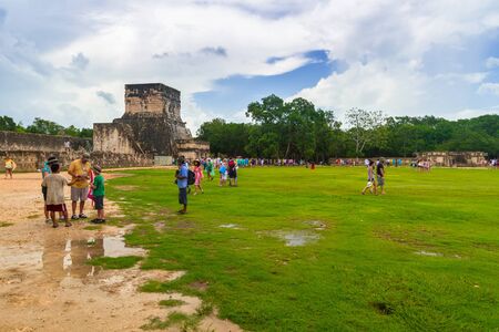 CHICHEN ITZA, MEXICO - JULY 12, 2011: Tourists visiting Kukulkan pyramid in Chichen Itza, Yucatan. Kukulkan pyramid is one of seven New World Wonders and popular tourist destination in Mexico.のeditorial素材