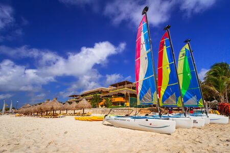PLAYA DEL CARMEN, MEXICO - JULY 11, 2011: Colorful sail catamarans on the beach of Playacar at Caribbean Sea of Mexico. This resort area is popular destination with the most beautiful beaches.のeditorial素材