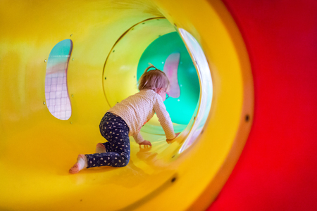 Little girl in the playground tunnelの写真素材