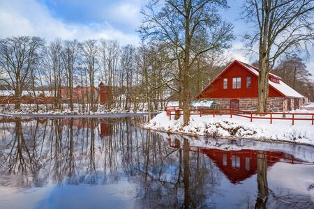 Winter scenery with red wooden house in Swedenの写真素材