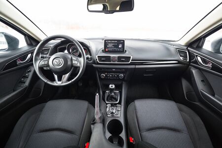 POLAND - FEBRUARY 11, 2018: Black interior of Mazda 3 captured in winter time. Mazda 3 is a popular compact car manufactured in Japan by the Mazda Motor Corporation.のeditorial素材