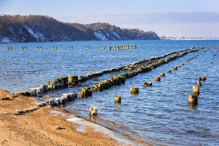 Frozen wooden breakwaters line at Baltic Sea, Babie Doly, Polandの写真素材