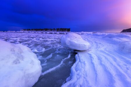 Frozen coastline of Baltic Sea in Gdynia at dusk, Polandの写真素材