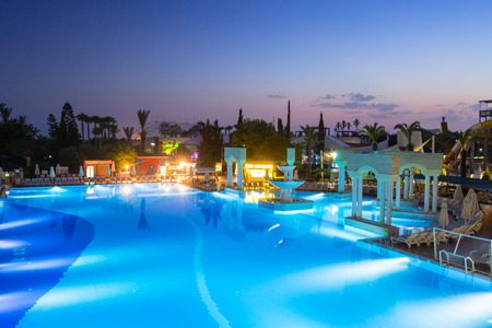 Side, Turkey - June 9, 2018: Beautiful pool area of the TT Pegasos World resort near Side at night, Turkey. Pegasos World Hotel is a 4-star resort with 9600 square metres of pool areas.のeditorial素材