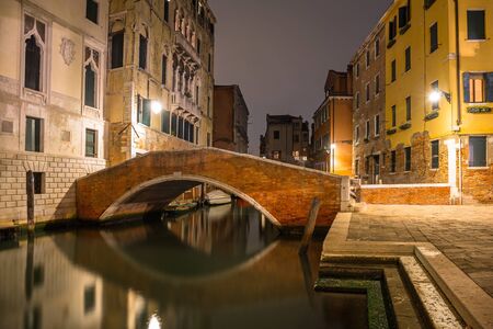 Canals of Venice city with beautiful architecture at night, Italyの写真素材