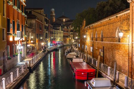 Canals of Venice city with beautiful architecture at night, Italyの写真素材