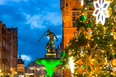 Long Lane and Neptune fountain in Gdansk with beautiful Christmas tree at dusk, Polandの写真素材