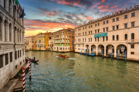 Venice, Italy - October 24, 2019: Canals of Venice city with boats and traditional colorful architecture at sunset, Italyのeditorial素材