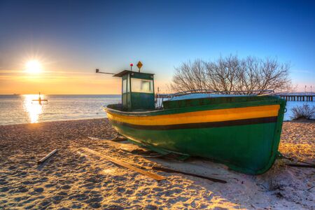 Fishing boats on the Baltic Sea beach at sunrise in Gdynia Orlowo, Polandの写真素材