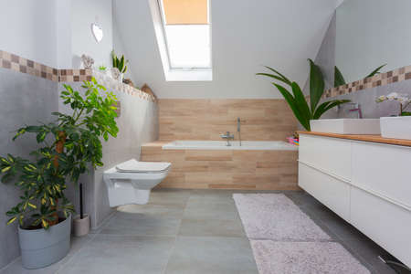 Modern bathroom interior with gray tiles and wooden decorsの写真素材