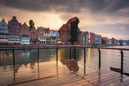Old town in Gdansk with historical port crane over Motlawa river at sunset, Poland.の写真素材