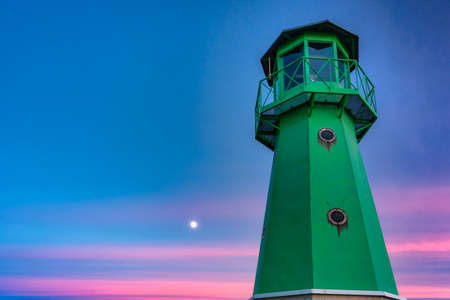 Lighthouse on the west breakwater in Nowy Port at dusk, GdaÅsk. Polandの写真素材