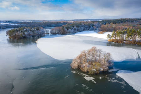 Aerial landscape of the frozen lake in Poland at winterの写真素材