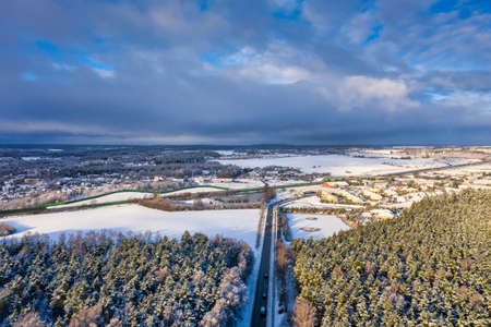 Aerial landscape of small village at the pine forest covered with fresh snowの写真素材