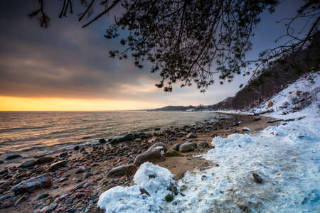 Snowy beach in Gdynia Orlowo at sunrise, Baltic Sea. Polandの写真素材