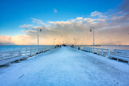 Beautiful sunset over the snowy pier (Molo) in Sopot at winter. Polandの写真素材