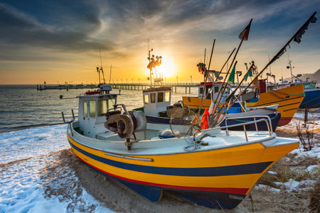 Fishing boat on the beach of Mechelinki by the Baltic Sea at sunrise, Poland.の写真素材