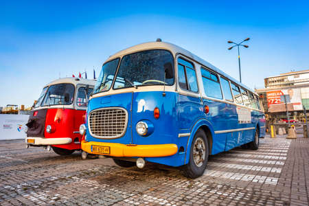 Warszawa, Poland - February 25, 2021: Vintage trip buses parked under the Palace of the Culture and Science in Warsaw city center, Poland.のeditorial素材