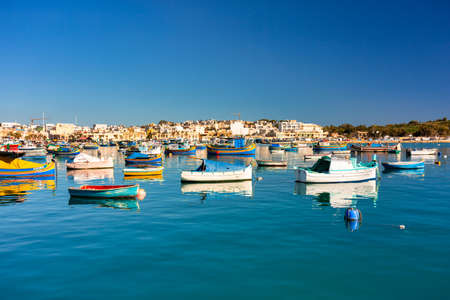Marsaxlokk, Malta - January 10, 2020: Traditional fishing boats in the Mediterranean Village of Marsaxlokk, Maltaのeditorial素材