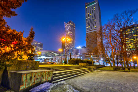 Warszawa, Poland - February 25, 2021: Amazing cityscape of Warsaw with metro station entrance by night, capital of Poland.のeditorial素材