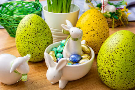 Easter Eggs with bunnies on the tableの写真素材