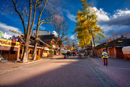 Zakopane, Poland - November 4, 2021: People on the main Krupowki street in Zakopane at autumn. Krupowki street is the main shopping and restaurant area in Zakopane, Poland.のeditorial素材