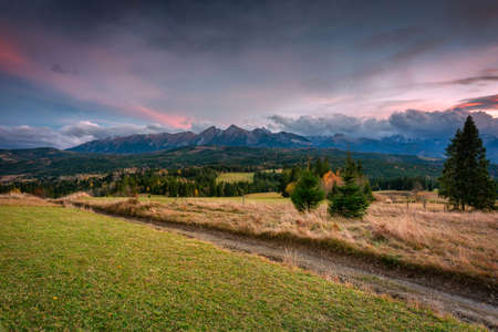 A colorful sunset over the autumnal Tatra Mountains. The pass over Lapszanka in Poland.の写真素材