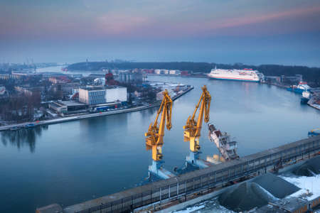 Scenery of port cranes by the Martwa Wisla river at sunset, Gdansk. Poland.の写真素材