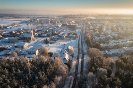 Aerial landscape of small village covered with fresh snow at sunriseの写真素材