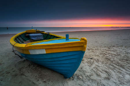 Fishing boat at sunrise on the Baltic Sea beach in Sopot. Polandの写真素材